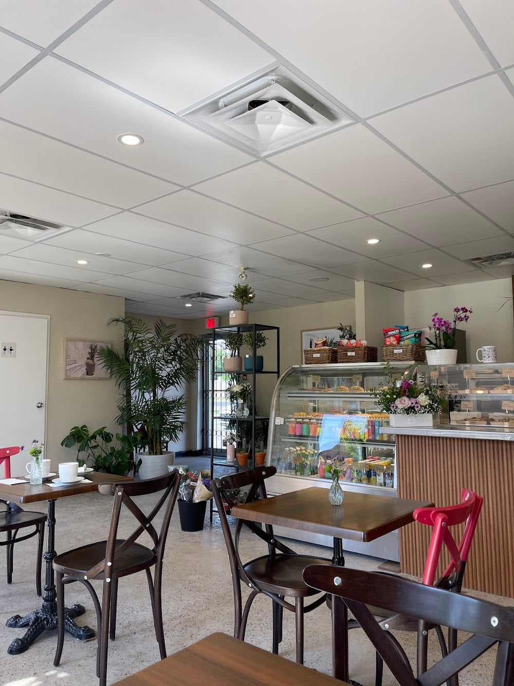 Café interior with furniture and natural light available for space rental at Nina Café Fleurs